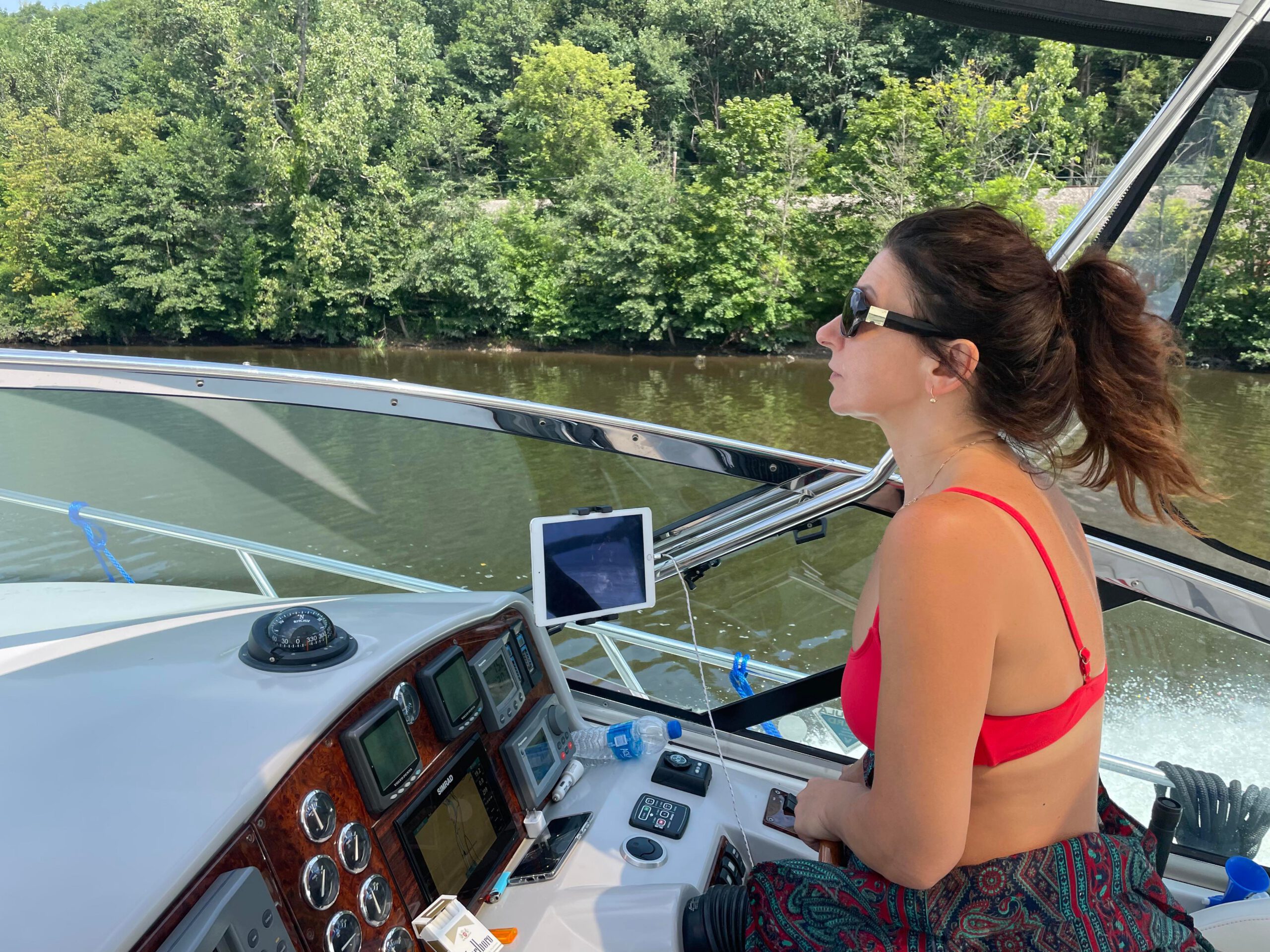 Iryna Granich at the helm during a boat delivery
